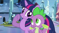 Twilight whispering to Spike.