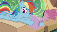 Rainbow holding a book written by Twilight S5E8