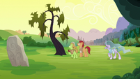 Apple farmer ponies in front of a dead tree S7E16