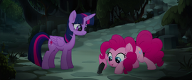 Pinkie Pie looking underneath a small rock MLPTM
