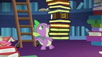 Spike carrying a tall stack of books S7E26