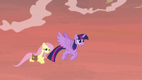Twilight and Fluttershy flying through the sky S7E20