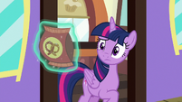 Twilight looks skeptical at bag of pretzels S7E2