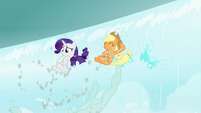 Rarity and Applejack pop out of the waterfall S7E16