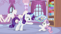 Rarity showing newspaper and her diary to Sweetie Belle S2E23