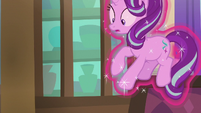 Starlight floating in Twilight's magic aura S8E15