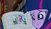 Twilight smiling with yearbook open EG