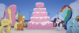 Main four looking at giant five-layer cake MLPTM