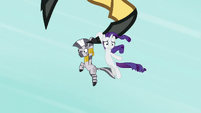 Rarity and Zecora hang from the roc's claw S8E11