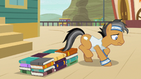 Quibble steps off a bed of books S9E6