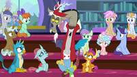 Discord sitting between the students S8E15