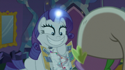 Rarity showing Spike brochure with big grin S9E19