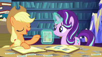 Applejack tells a story about the photo S6E21