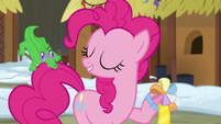 Pinkie proudly holding her ambassador ribbon S7E11