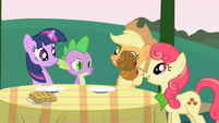Apple Bumpkin drops candy apples on the table S1E01