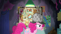 Pinkie Pie crosses in front of her theory board S7E23