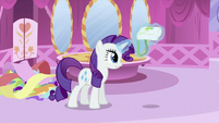 Rarity magically picking up the saddlebag.