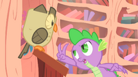 Spike holding two claws up to Owlowiscious S1E24