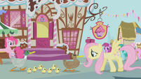 Fluttershy leads the ducks past Sugarcube Corner S1E05