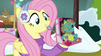 Fluttershy pulling Holly doll's pullstring MLPBGE