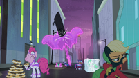 Rarity forming an umbrella shielding herself from the falling neon sign S4E06