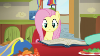 Zephyr showing Fluttershy a book of mane styles S6E11