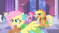 Fluttershy holding a squirrel in her mouth S1E26