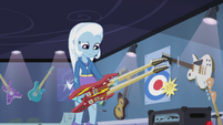 Trixie realizes that she can't use that guitar. The whammy bar (tremolo arm) is placed so only a right handed person could play it. And she's a lefty.
