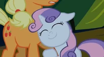 Sweetie Belle hugging Applejack's leg.