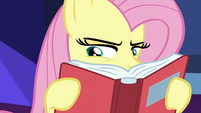 Fluttershy intensely peruses through the books S7E20