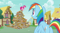 Pinkie Pie standing on a pyramid of pies S7E23