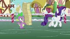 Spike holding restacked flyers; Rarity trots away S7E9