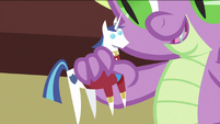Spike playing with figurine of Shining Armor S2E25