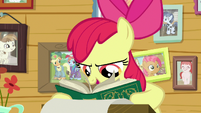 Apple Bloom looks through creature book S9E12