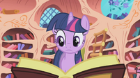 Twilight looking through a book.