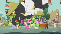The Flower ponies look at Derpy while a bugbear is flying S5E9
