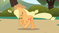 Applejack running towards a tree.