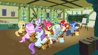 If you look closely, in the front right seat is a filly with Scootaloo's model, and in the front left seat is a filly with Sweetie Belle's model.