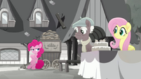 Pinkie leaning against Moody Root's cart MLPRR