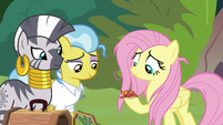 Fluttershy holding the gecko in her hoof S9E18