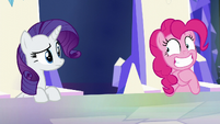 Rarity looks at Pinkie grinning S5E19