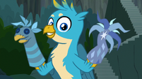 Gallus holding puppets of himself and tree S9E3