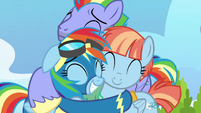 Rainbow Dash happily hugging her parents S7E7