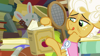 Goldie Delicious looks through history book S7E13