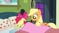 Applejack covering Apple Bloom with a blanket S3E08
