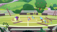 Wide view of cheer squad on the field S9E15