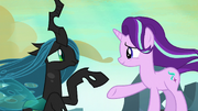 Queen Chrysalis reaching for Starlight Glimmer's hoof S6E26