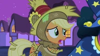 Applejack watches what Princess Luna is doing with concern.