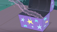 Chains levitating out of a supply trunk S7E24