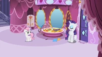 Rarity gives orders to Sweetie Belle.